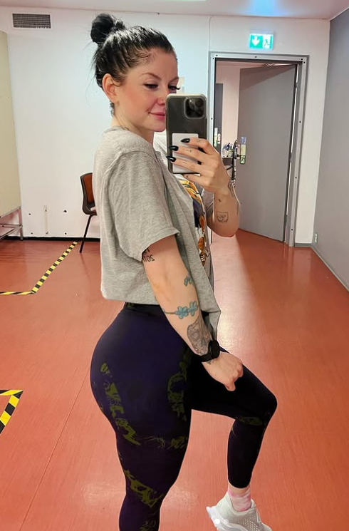 Ann Helen Lund tar et bilde kledd i en grå topp og leggings.